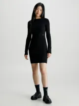 Vestido corto negro de punto de algodón orgánico, con cuello redondo, mangas largas y espalda descubierta con cierre de gancho.