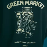 Canguro negro con capucha y bolsillo delantero. Estampado pequeño en el pecho de un carrito de supermercado lleno de productos.