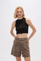 Top negro sin mangas de poliamida, corte ajustado, con cuello alto y cierre frontal con cremallera.