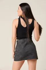Minifalda negra de corte ajustado, con cierre metálico frontal y dos bolsillos con cierre en la parte delantera.