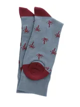 Calcetines largos celestes con diseño de palmeras rojas y puntera y talón en color borgoña.