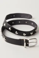 Cinturón de cuero negro con tachas metálicas plateadas y hebilla metálica plateada.