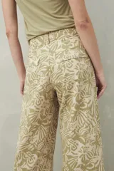 Pantalón ancho de algodón con estampado botánico en tonos verde y beige, corte recto y bolsillos de parche.