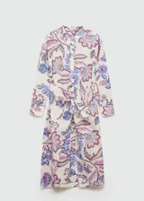 Vestido midi de corte camisero con estampado floral en tonos rosa, azul y marrón sobre fondo blanco. Tiene cuello mao, mangas 3/4 con puños abotonados, cierre frontal con botones y lazo decorativo en la cintura.
