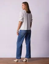 Blusa blanca de cuello redondo con apertura central y botones. Mangas 3/4 con detalle de bordado calado.
