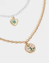 Collar corto doble de metal dorado, con una cadena de perlas y dije de corazón con flores esmaltadas, y otra cadena con dije redondo con flores esmaltadas.