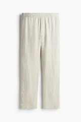 Pantalón de lino color beige, corte recto, con cintura elastizada y cordón de ajuste.