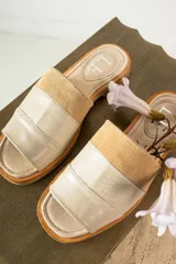 Sandalias de cuero negras con diseño de tiras cruzadas y detalle de elástico en el talón.