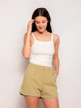 Short color verde militar, tiro alto, corte amplio, con pinzas en el frente, bolsillos laterales y traseros, y dobladillo arremangado.