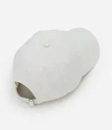 Gorra de sarga color gris claro con efecto lino, visera curva y hebilla trasera ajustable.