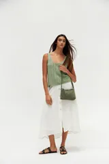 Musculosa verde tejida con breteles finos y escote redondo.