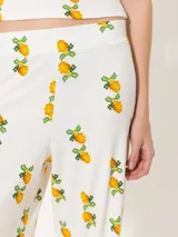 Pantalón palazzo blanco con estampado de limones, confeccionado en ribb con cintura elastizada.