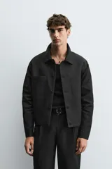 Sobrecamisa negra relaxed fit confeccionada en tejido con algodón, lino y lyocell. Cuello solapa y manga larga acabada en puño con botón. Bolsillos plastrón con solapa en pecho y laterales en cadera. Cierre frontal de botonadura.