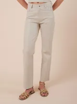 Pantalón de cuero ovino color beige, de corte recto y tiro medio. Presenta bolsillos laterales y traseros.