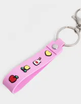 Llavero con monedero de silicona con forma de la cara de Hello Kitty, con moño rojo y correa rosa con dijes.