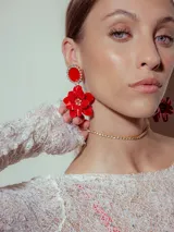 Aros colgantes con forma de flor roja y base circular con strass.