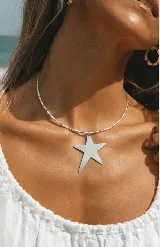 Gargantilla rígida plateada con dije de estrella.