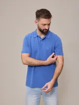 Remera polo celeste de piqué de algodón, corte clásico, con cuello y mangas acanalados.