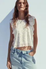 Pantalón de jean celeste de tiro alto con cintura doblada, cinco bolsillos, efecto lavado y roturas.
