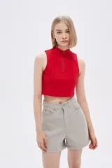 Top rojo de algodón con cuello alto, cierre frontal con cremallera y diseño sin mangas.
