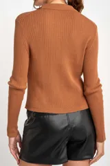 Cardigan negro de tejido de punto acanalado, con cuello polo, corte al cuerpo y cierre frontal con botones.