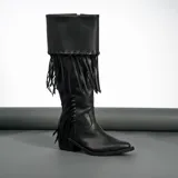 Bota tejana de cuero negro con flecos, diseño de punta fina, con taco de madera de 5 cm de altura.