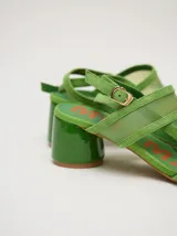 Sandalias de gamuza color negro con tiras transparentes de poliuretano, taco redondo y tiras finas al tobillo.