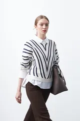 Sweater tramado y calado a rayas blancas y azul marino, con escote en V y mangas largas.