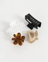 Set de cuatro broches para el pelo de diferentes formas y colores: blanco, negro, beige y carey.