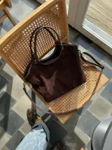 Cartera tote de gamuza color chocolate, con forro interior y correa larga desmontable.