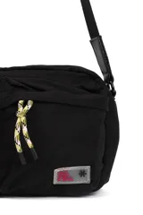 Bandolera color beige con correa negra ajustable, cierre superior y dos bolsillos frontales con cierre.