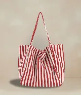 Bolso tote de tela color crudo con rayas verticales azules.