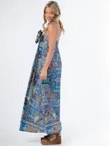 Vestido largo de algodón con estampado geométrico multicolor, corte cuadrado, elástico en la espalda y tirantes finos. Incluye aplique de flor desmontable.