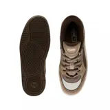 Championes Puma 180 color beige con detalles en blanco.