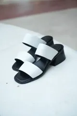 Sandalias de cuero blancas con dos tiras anchas y taco bloque negro de 3 cm.