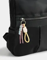 Mochila negra de tela deportiva con bolsillo frontal con cierre, tiracierres de cordón y etiqueta de goma. Tiene correas regulables, manija superior y cierre superior.