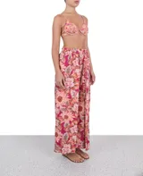 Pantalón palazzo con cintura elastizada y estampado floral en tonos fucsia, naranja y marrón.