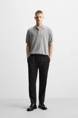 Pantalón color arena de corte recto, confeccionado en tejido elástico. Cuenta con cintura elástica ajustable con cordón, bolsillos laterales y bolsillos de vivo en la parte trasera.