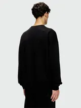 Buzo negro de algodón con logo ovalado Diesel en relieve en el frente.