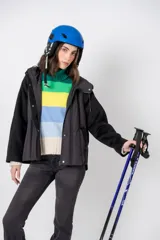 Campera negra con mangas de lana y cuerpo de nylon acolchado, con capucha y cierre frontal con botones a presión.