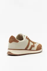 Zapatillas beige con recortes en gamuza de diferentes tonos, cordones y suela irregular blanca con detalle rosa.