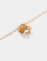 Collar corto dorado con cadena de eslabones y dije de perla con strass, corazón y rosa.