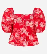 Blusa peplum cropped de tricolina con estampa floral, escote cuadrado, mangas abullonadas cortas y botones delanteros.