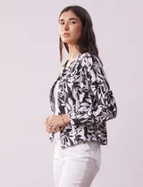 Chaqueta de lino estampada en blanco y negro, marca Zac & Rachel. Cuello a la base y abertura central con botones. Delantera con bolsillos.