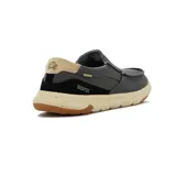 Zapato casual de hombre color gris oscuro, tipo mocasín, con elásticos laterales, detalle de costuras en contraste y suela de goma color beige con detalles marrones.