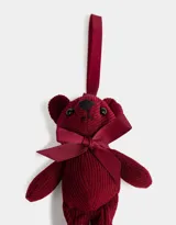 Llavero con dije de oso de peluche de corderoy color borgoña, con moño de cinta de raso al cuello y cinta para colgar.