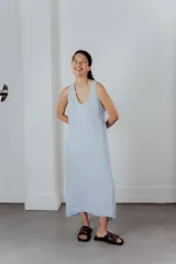 Vestido midi gris oscuro de lino, corte recto y sin mangas. Tiene bolsillos laterales y cuello redondo.