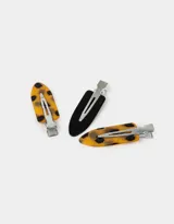 Set de cuatro hebillas para el pelo tipo piquitos, dos color piel y dos color negro, con gancho plateado.