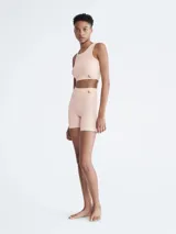 Shorts de ciclismo color beige, de tiro alto, con logo de Calvin Klein en la cintura.