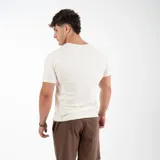 Remera negra de algodón y elastano, corte slim fit, con cuello redondo y logo 'GAINS' estampado en el pecho.